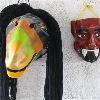 Some finished masks hang on the wall