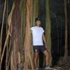 Standing amongst the tree roots under the ground in a cave.
